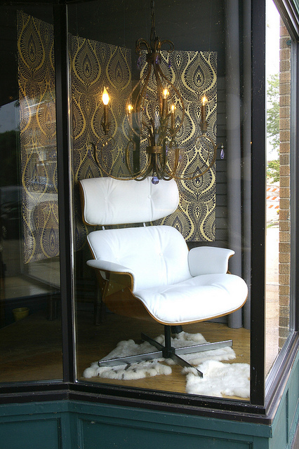 eames chair w/chandelier and sheepskin rug