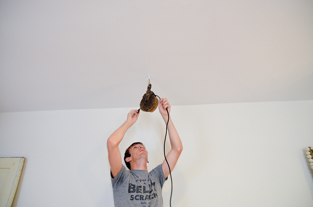 man changing lighting in apartment 