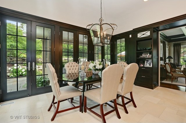 This room makes a dramatic statement with dark walls and trim, which really make the pale flooring and neutral furniture pop.