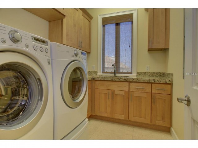 Natural wood and soft wall colors make the laundry space in this Redington Beach, FL brings the beach to a home...without the sand, of course.