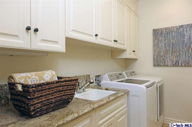 Adding wall art, or a pretty catch-all basket can bring your laundry room to life, like in this California home.