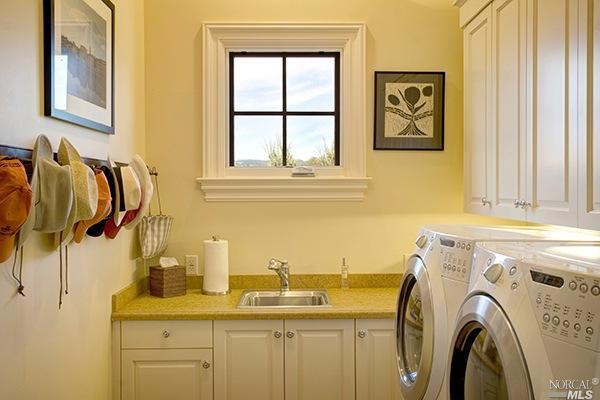 Natural light can make a big difference in a laundry room.  We love the square window in the laundry room of this St. Helena, California home.