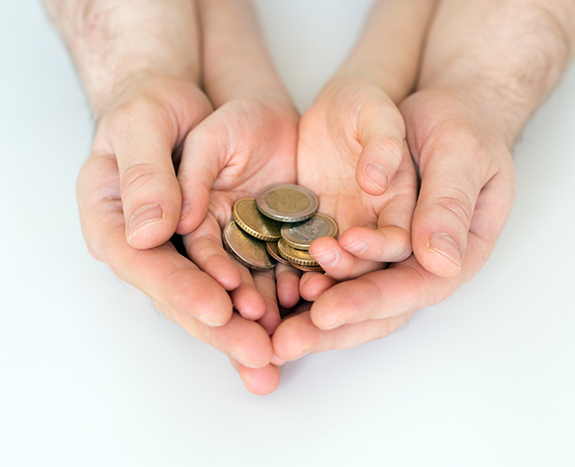 Dad and his daughter holding euro coins.