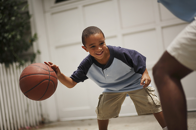 Father and son playing basketball