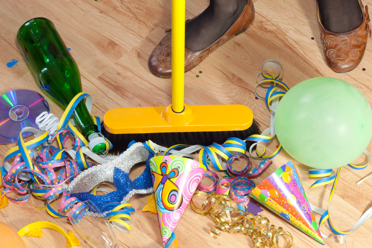 Messy room after party next day and woman cleaning