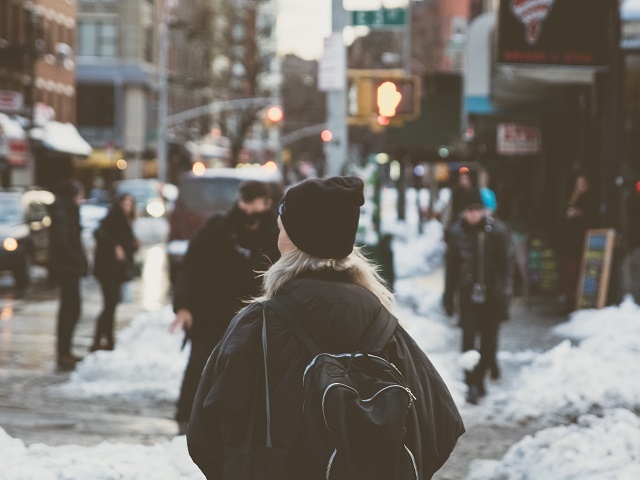 woman walking in the city snow