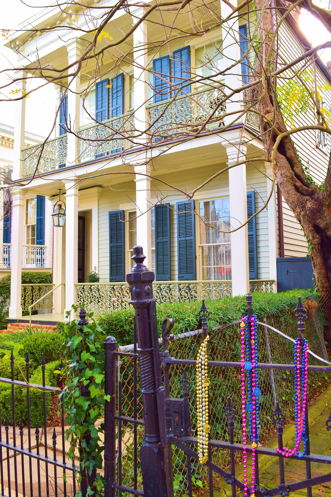 Mardi Gras Beads displayed on a fence at a residential neighborhood taken in New Orleans, LA